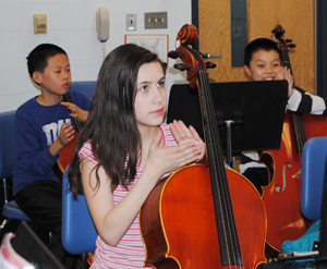 Students learning to play cello