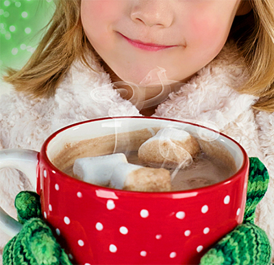 smiling young girl holding cup with cocoa and marshmallows